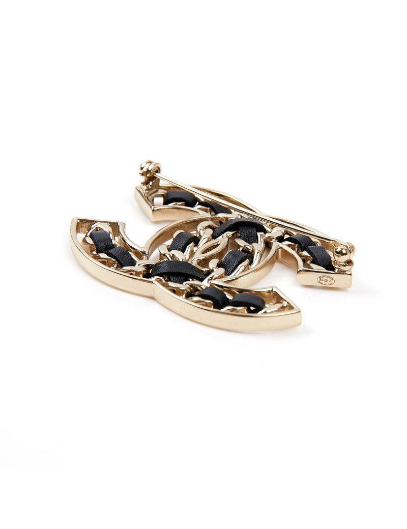 Broche CHANEL métal or entrelacée de cuir noir