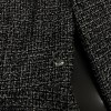 Veste T34 CHANEL en tweed noir et blanc avec fil doré. Fermeture avec zip et deux poches passepoilées sur le devant