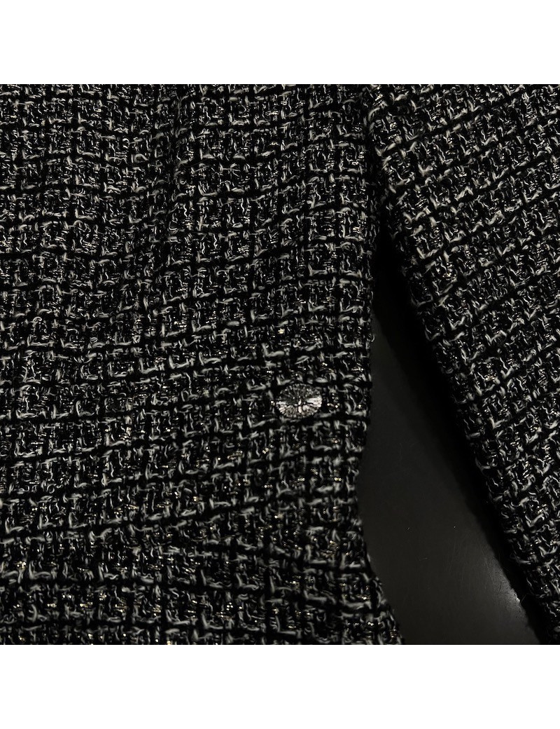 Veste T34 CHANEL en tweed noir et blanc avec fil doré. Fermeture avec zip et deux poches passepoilées sur le devant
