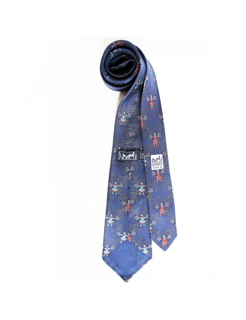 Cravate bleu nuit HERMES avec des imprimés de jongleurs