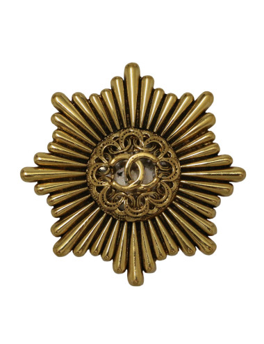 Broche Chanel starbust dorée vintage 1983