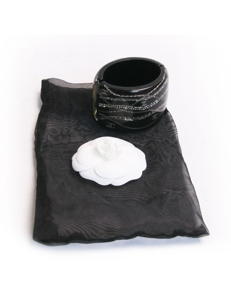 Manchette CHANEL noire avec inclusion chaînes et brillants