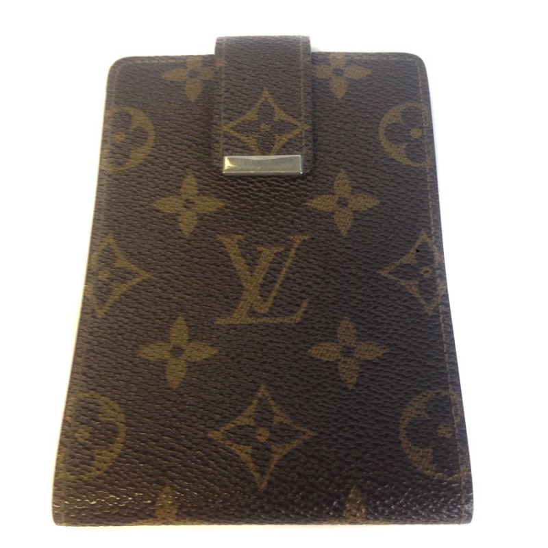Wearing LOUIS VUITTON checkbook in monogrammed and leather coated