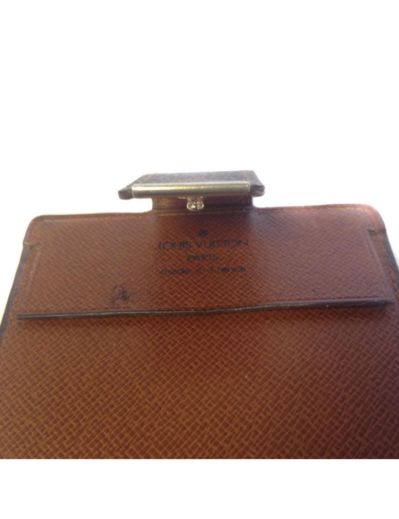 Wearing LOUIS VUITTON checkbook in monogrammed and leather coated canvas