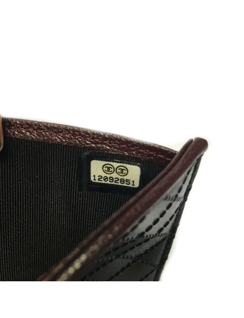 Portefeuille CHANEL en cuir noir tressé et contour bordeaux