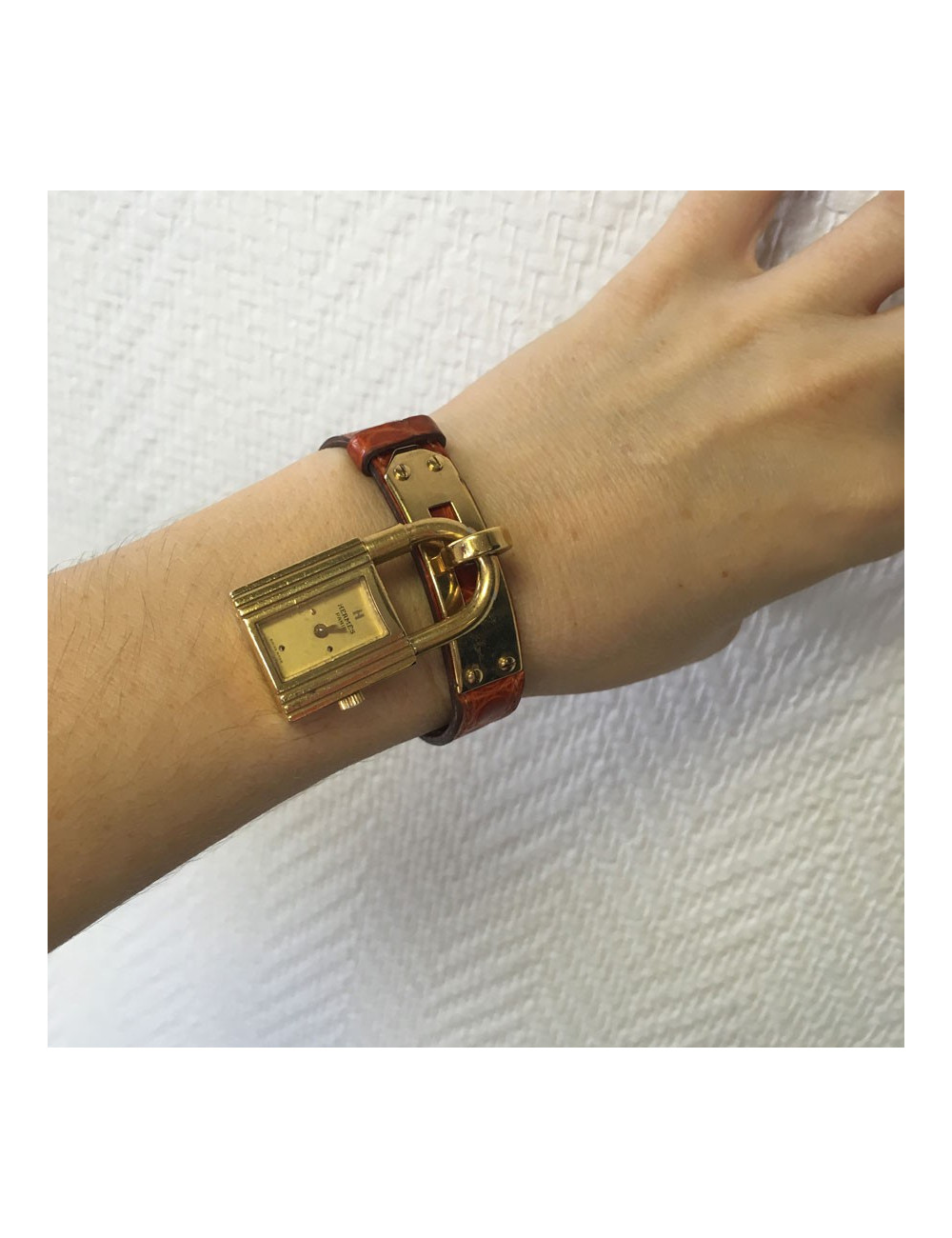 HERMES Kelly watch with ora,ge crocodile bracelet and gilded hardware