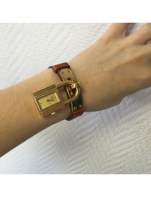 HERMES Kelly watch with ora,ge crocodile bracelet and gilded hardware