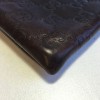 GUCCI monogram embossed brown leather pouch