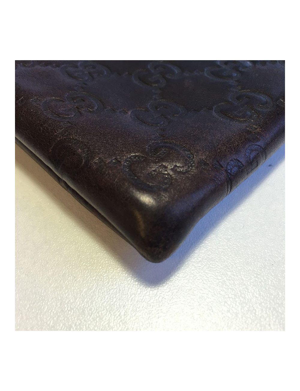 GUCCI monogram embossed brown leather pouch