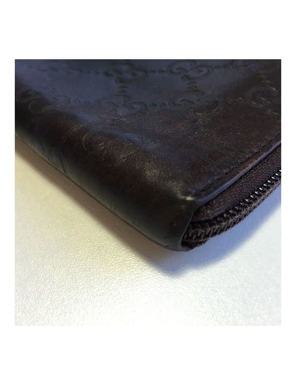 GUCCI monogram embossed brown leather pouch