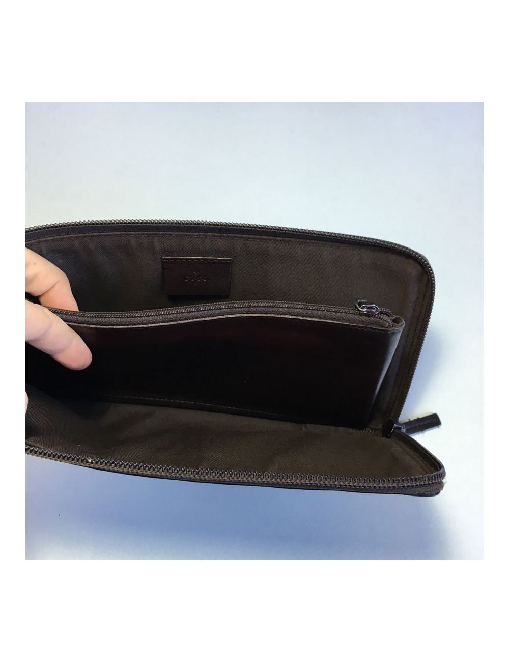 GUCCI monogram embossed brown leather pouch