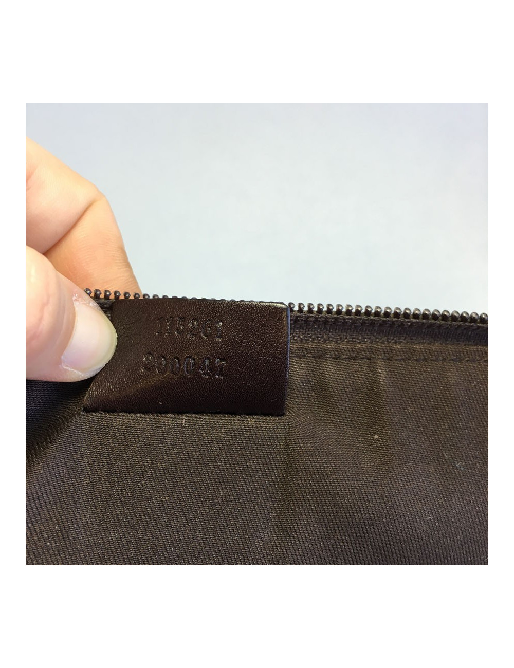 GUCCI monogram embossed brown leather pouch