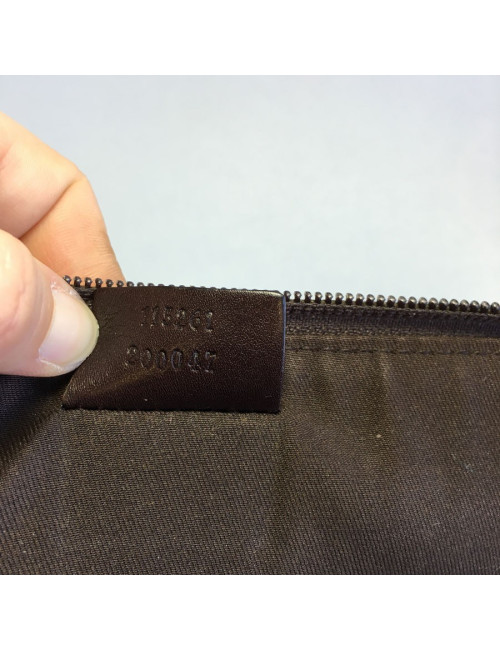 GUCCI monogram embossed brown leather pouch