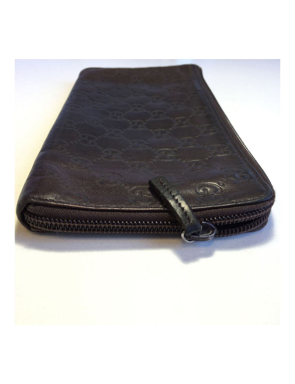 GUCCI monogram embossed brown leather pouch