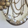 Collier CHANEL multiple rangs de perles, chaînes et pièce en métal doré