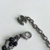 Collier CHANEL triple rangs en métal argenté, perles noires et strass blancs et noirs
