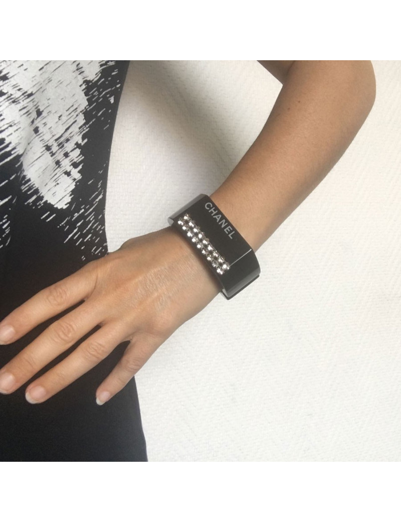 CHANEL cuff in black plastic and inclusion of white rhinestones