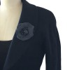In black silk CHANEL Camellia brooch