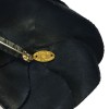In black silk CHANEL Camellia brooch