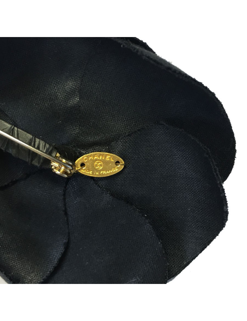 In black silk CHANEL Camellia brooch