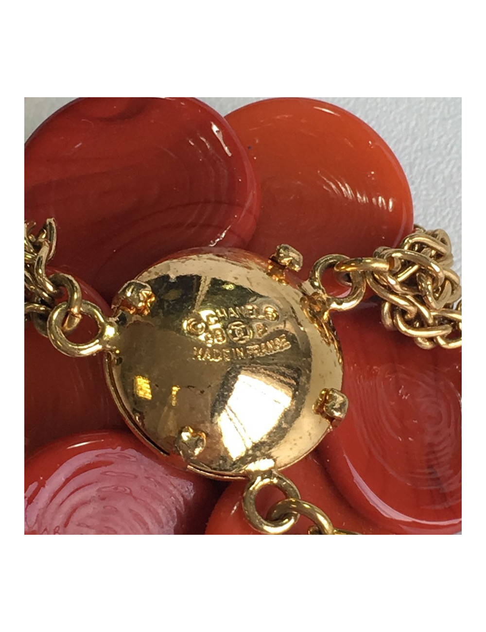CHANEL couture necklace in gilded metal and camellia pendant in orange molten glass