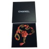CHANEL couture necklace in gilded metal and camellia pendant in orange molten glass