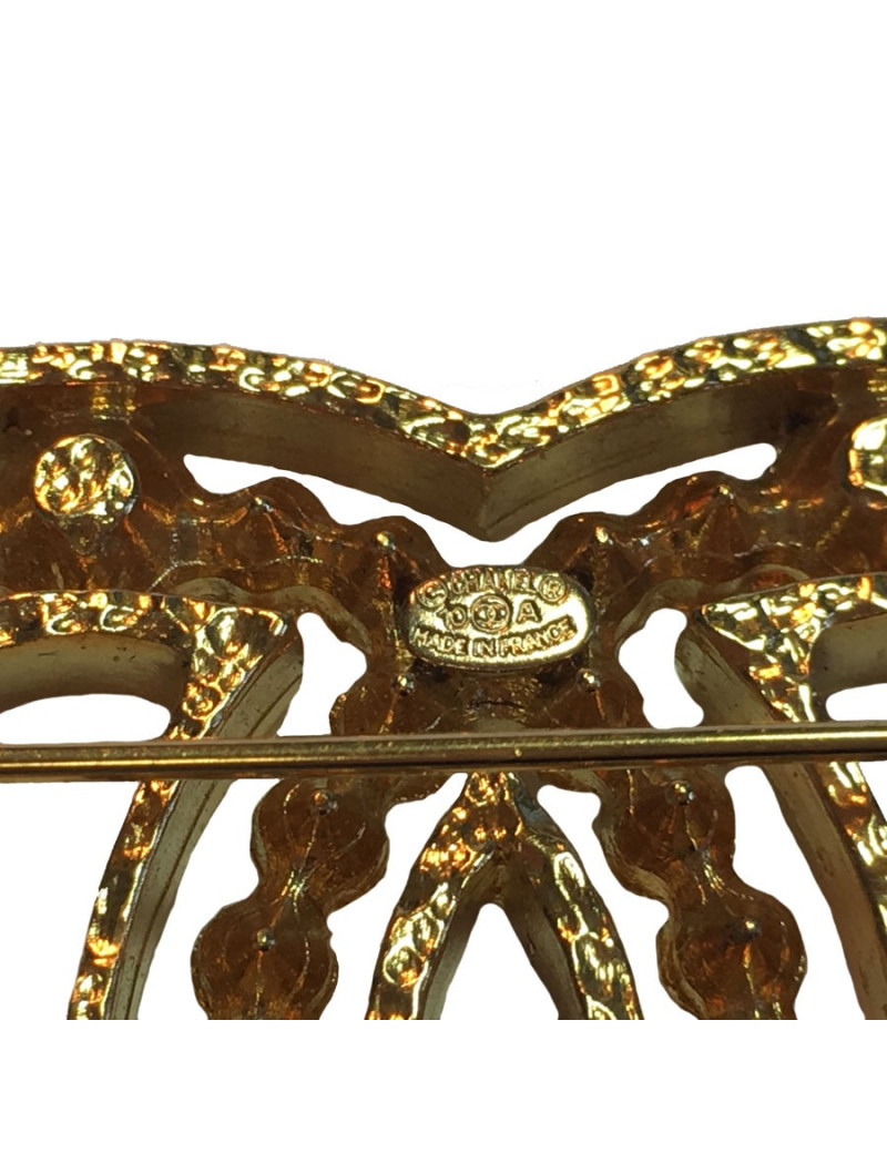 Broche CHANEL en métal doré et strass