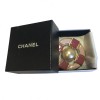 CHANEL round brooch in gilded metal and pink molten glass