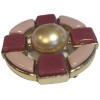 CHANEL round brooch in gilded metal and pink molten glass