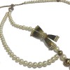 CHANEL pearls belt with a gilded metal bow set with rhinestones