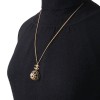 Collier CHANEL en métal doré, pendentif serti de petites perles noires