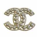 CHANEL CC Brooch in gilded metal set with pearl beads
