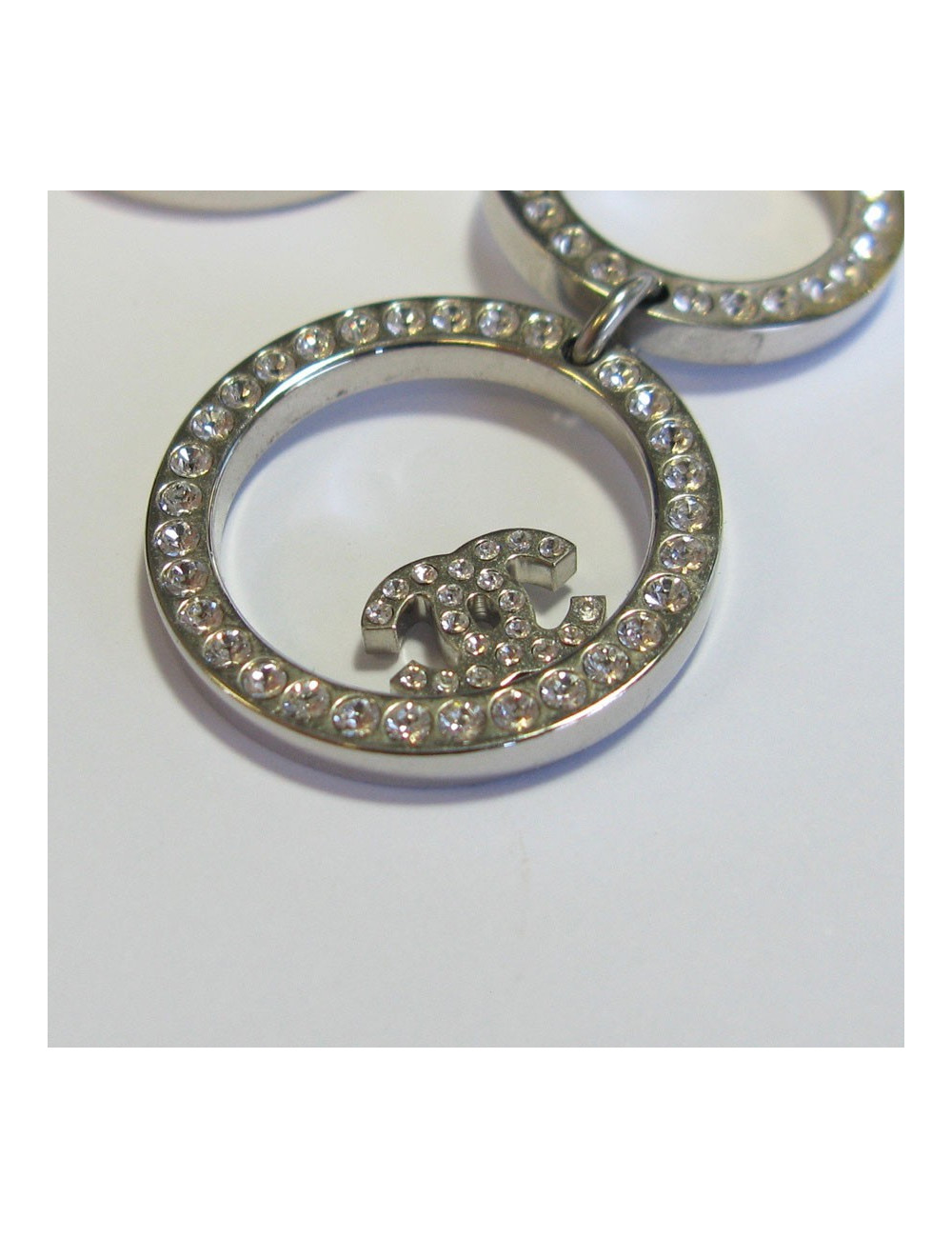 Boucles d'oreille CHANEL pendantes en métal argenté serties de strass blancs