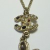 CHANEL pendant necklace in gilded metal and molten glass