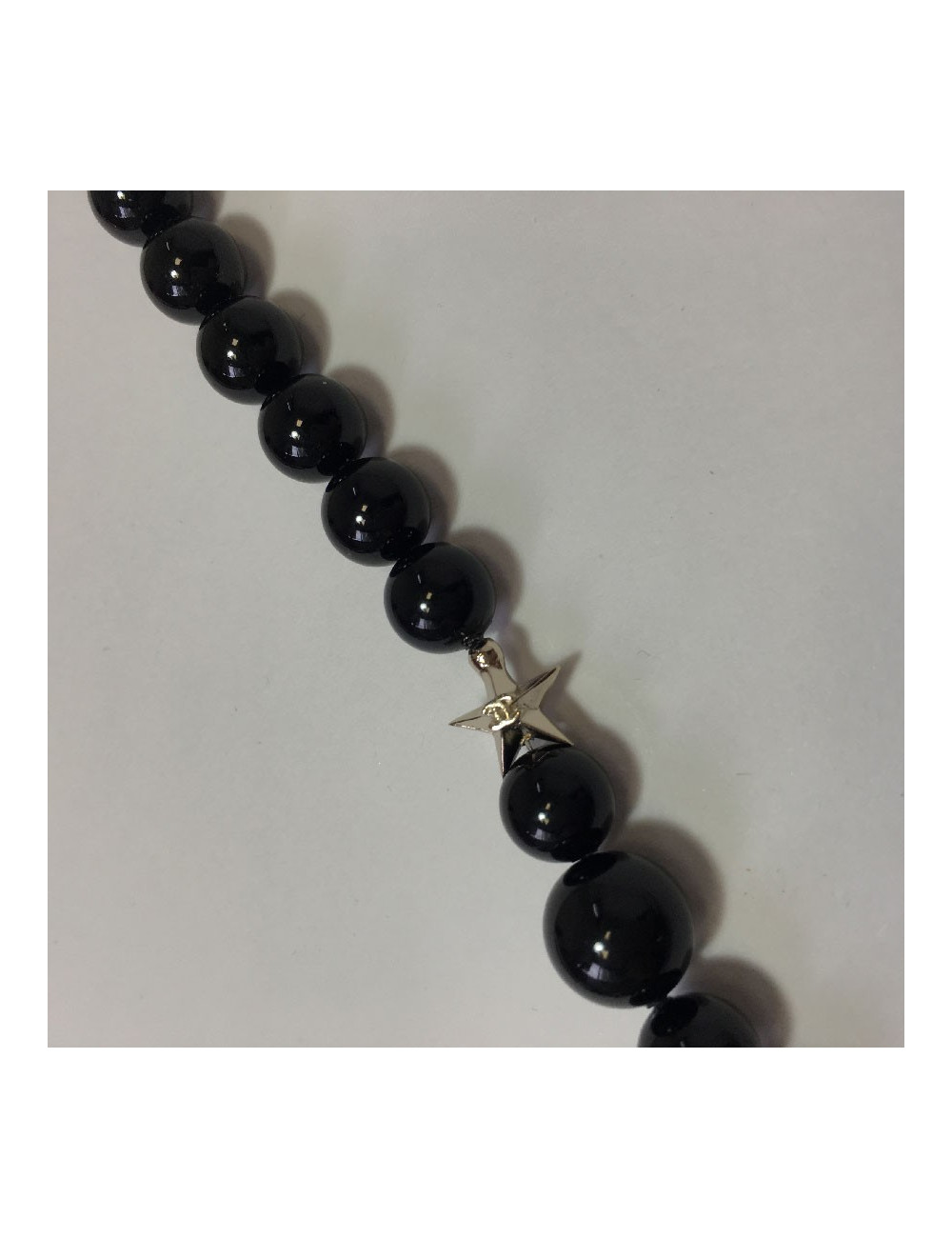 CHANEL Long necklace in black pearls, golden CC and stars