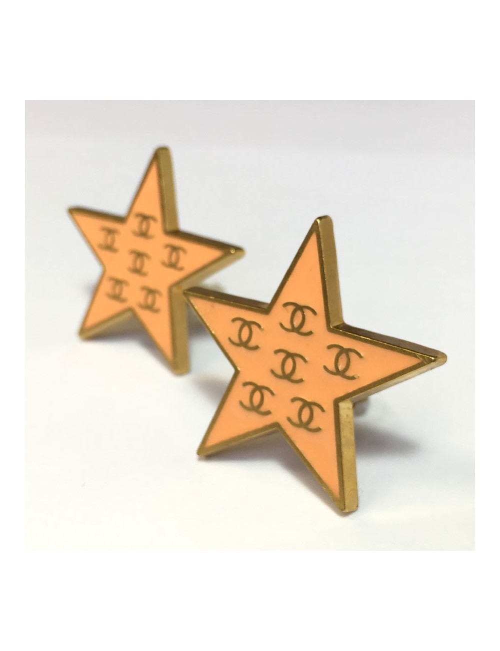 CHANEL star clip-on earrings in gilded metal and coral enamel