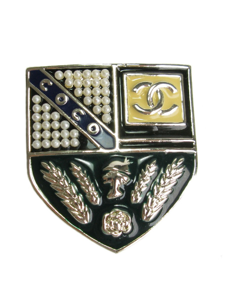 CHANEL escutcheon brooch in pale gilded metal, pearls and colored resin