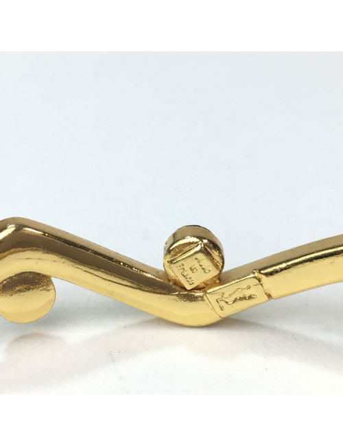 Bracelet rigide YVES SAINT LAURENT métal doré et strass rubis et améthyste