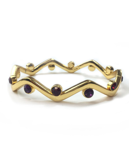 Bracelet rigide YVES SAINT LAURENT métal doré et strass rubis et améthyste