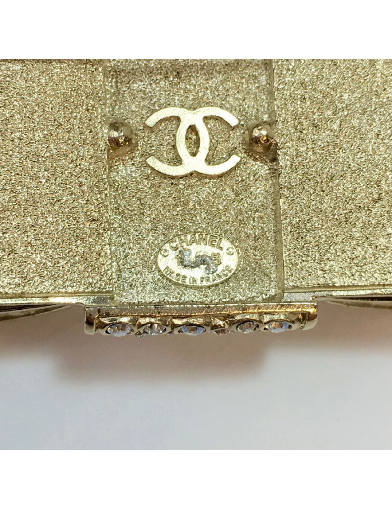 CHANEL knot brooch in rhinestones and pale gold metal