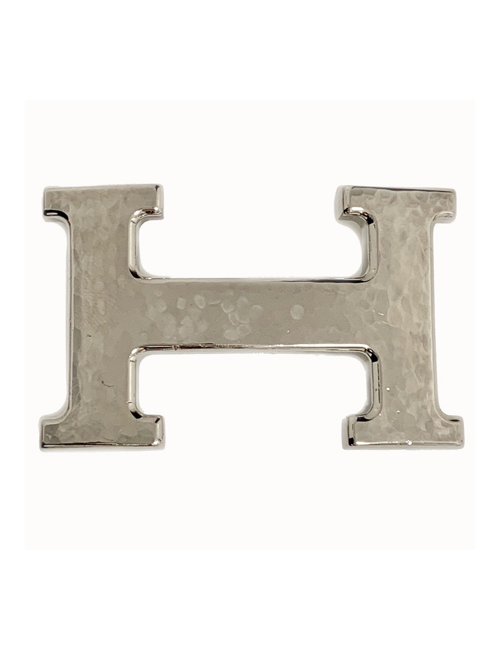 Boucle H HERMES en métal argenté martelé