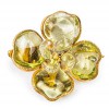 CHANEL camélia brooch in gilded metal and green molten glass