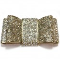 CHANEL knot brooch in rhinestones and pale gold metal